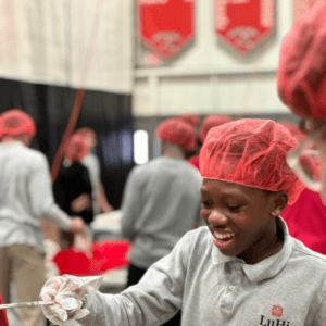 student smiling during meal packing