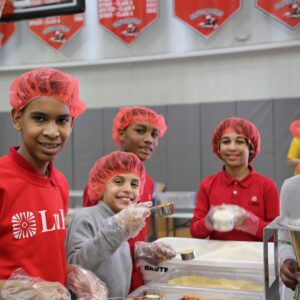 Students during the meal packing event smiling together