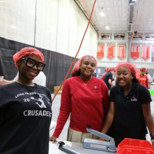 group of students smiling during meal packing