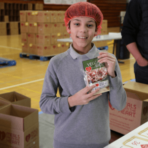 student smiling during meal packing